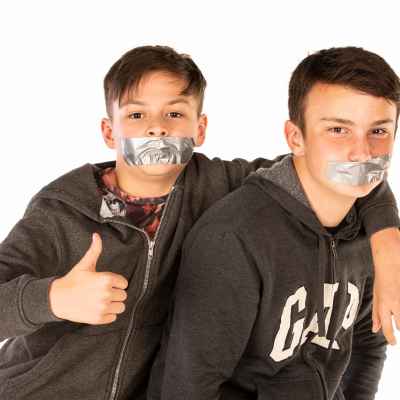 2 boys with tape on their face